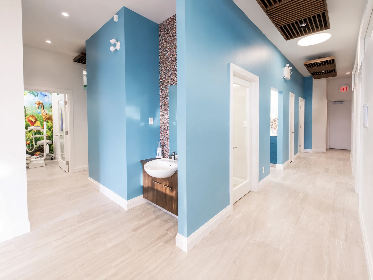 Hallway with a built-in sink station and mosaic accent