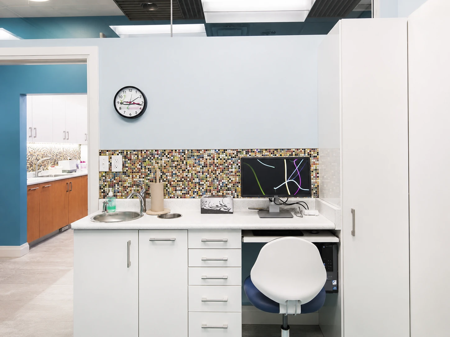Hallway workstation with a clock and mosaic backsplash